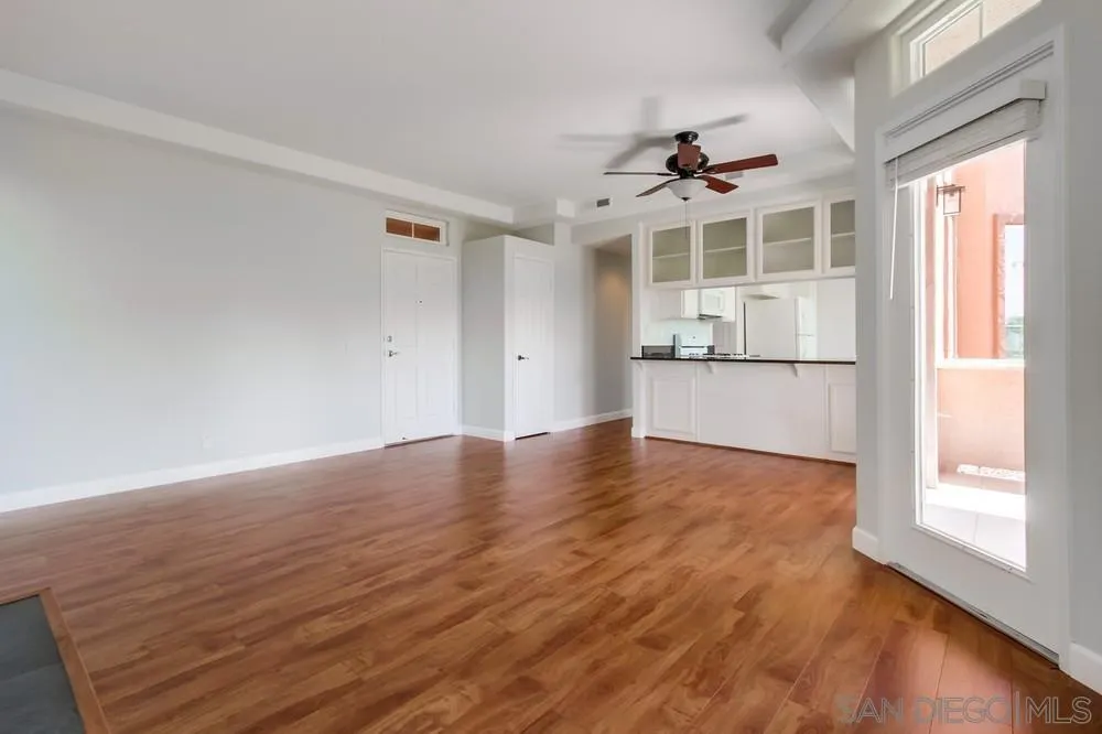 3525 Cameo Drive, Unit 92 Oceanside, CA 92056 - Photo 8 of 43 an empty room with wooden floor and windows