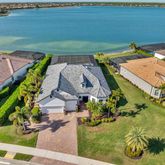 an aerial view of a house with garden space and ocean view
