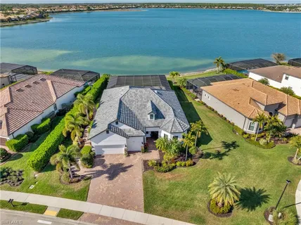 an aerial view of a house with garden space and ocean view