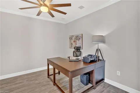 a view of a workspace with furniture and wooden floor