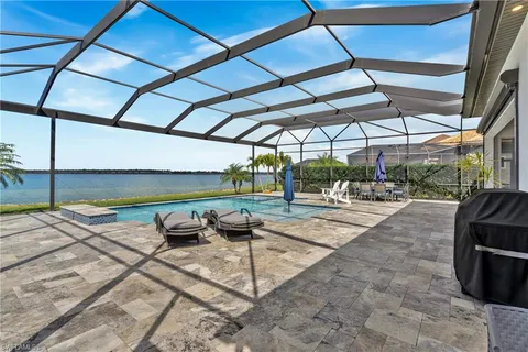 a view of a house with swimming pool and sitting area
