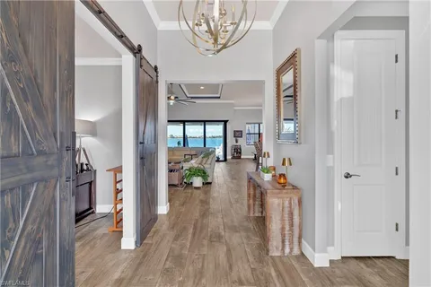a very nice looking room with wooden floor and a chandelier