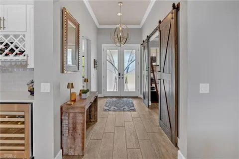 a living room with furniture and large windows