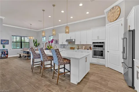 a kitchen with cabinets a sink and a stove top oven