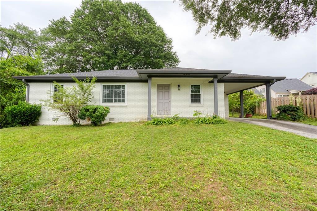375 Wright Street Southwest Marietta, GA 30064 - Photo 1 of 1 a house that is sitting in the grass
