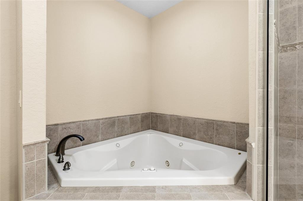150 164th Avenue Redington Beach, FL 33708 - Photo 24 of 64 a white bath tub sitting in a bathroom