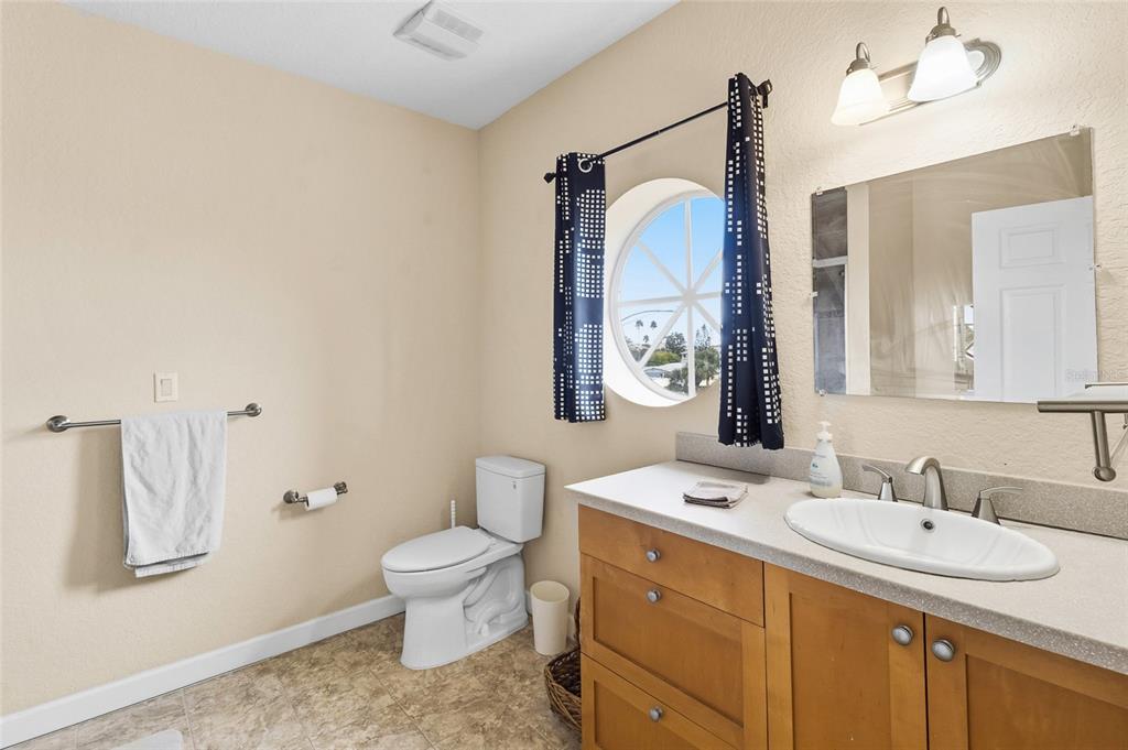 150 164th Avenue Redington Beach, FL 33708 - Photo 30 of 64 a bathroom with a sink vanity mirror and toilet