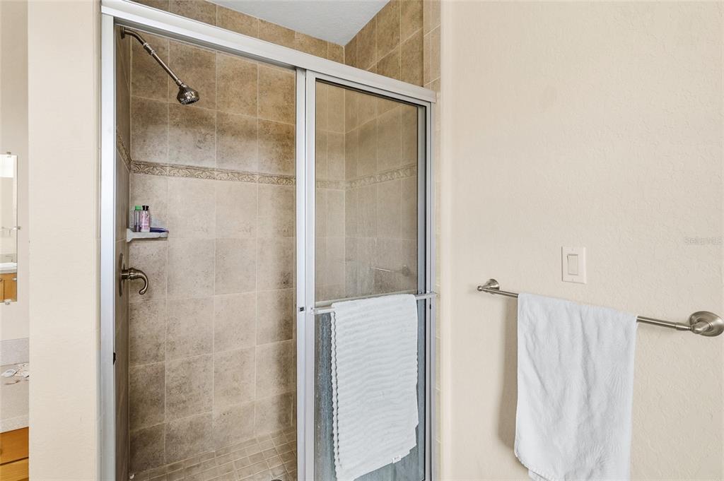 150 164th Avenue Redington Beach, FL 33708 - Photo 31 of 64 a bathroom with a glass shower door