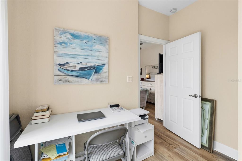 150 164th Avenue Redington Beach, FL 33708 - Photo 41 of 64 a view of a workspace with furniture and wooden floor