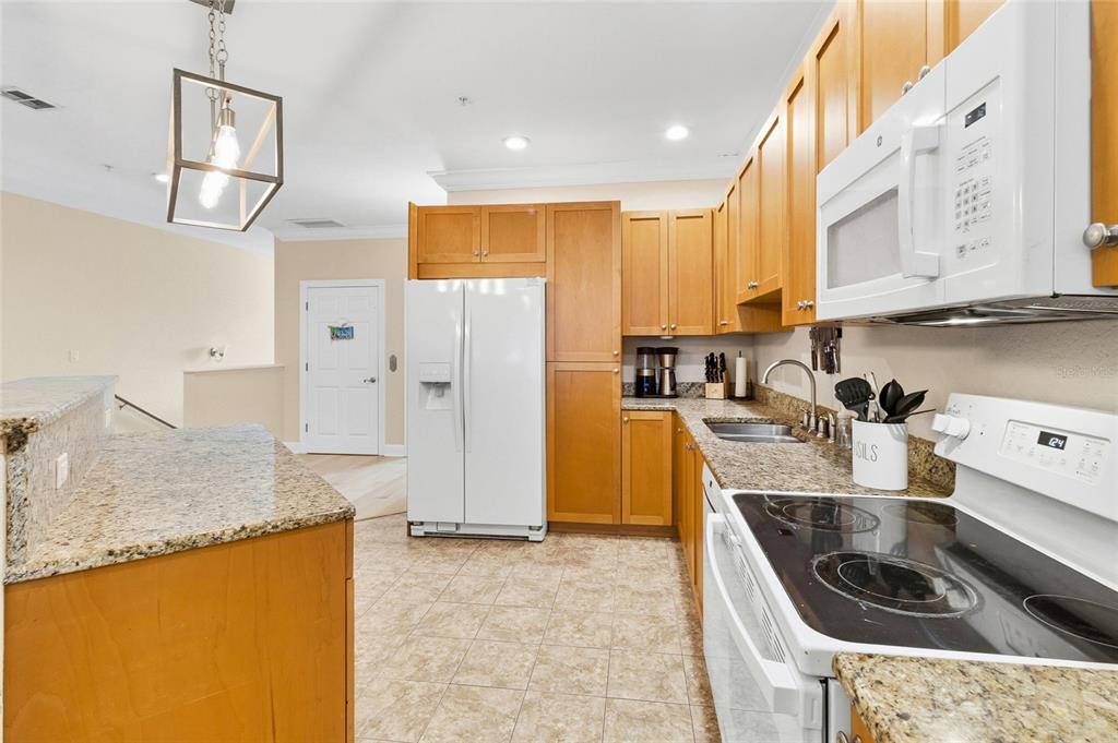 150 164th Avenue Redington Beach, FL 33708 - Photo 6 of 64 a kitchen with granite countertop a sink a stove and a refrigerator