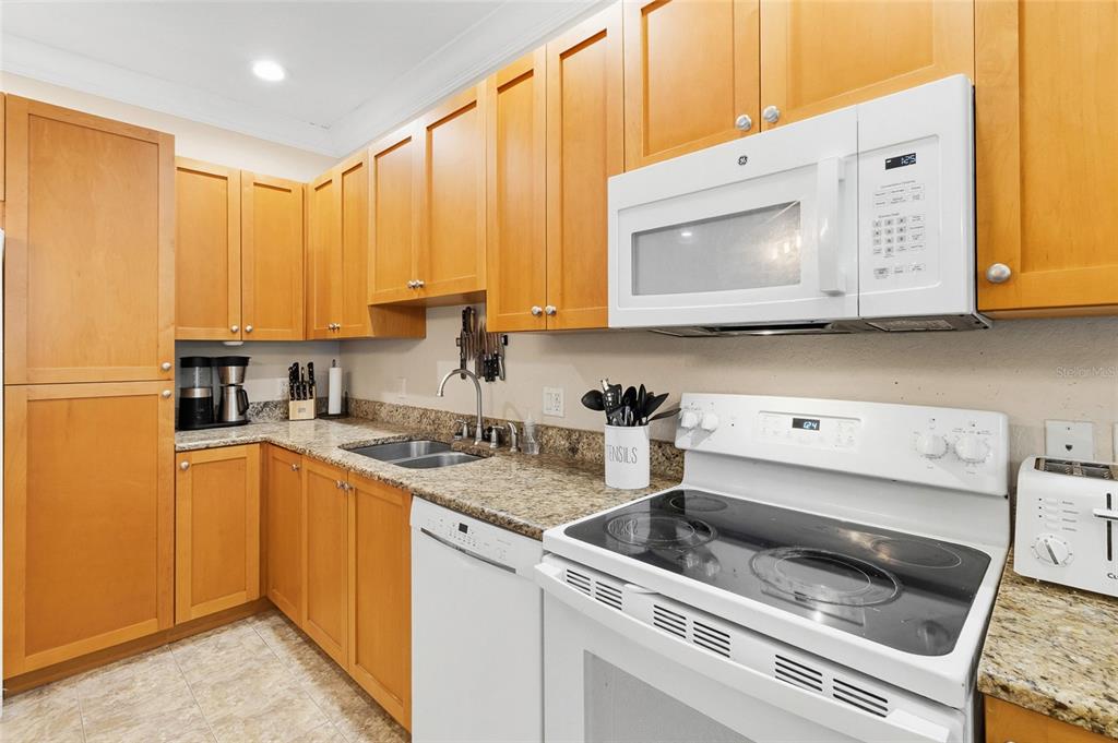 150 164th Avenue Redington Beach, FL 33708 - Photo 8 of 64 a kitchen with a sink stove and cabinets