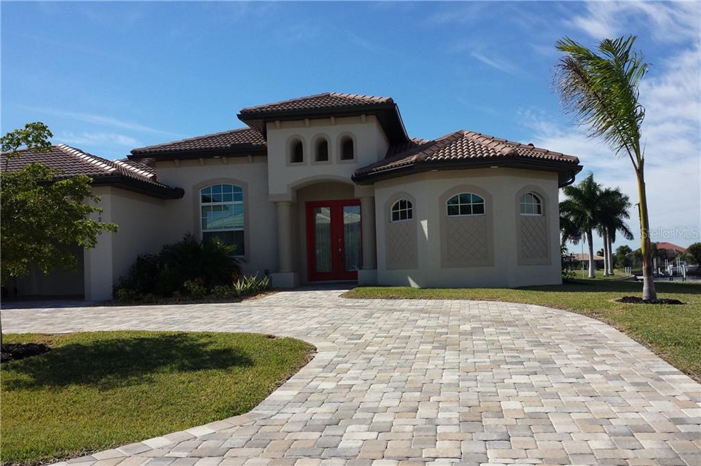 1215 Riding Rocks Lane Punta Gorda, FL 33950 - Photo 1 of 1 a front view of a house with a yard