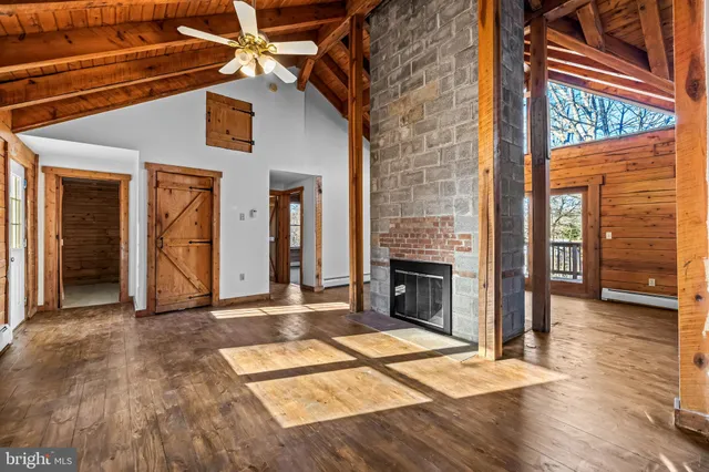 a view of a livingroom with a fireplace and wooden floor