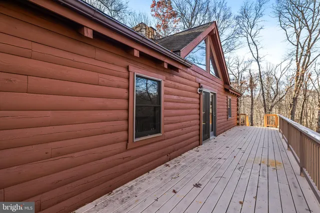 a view of backyard with a deck and wooden floor