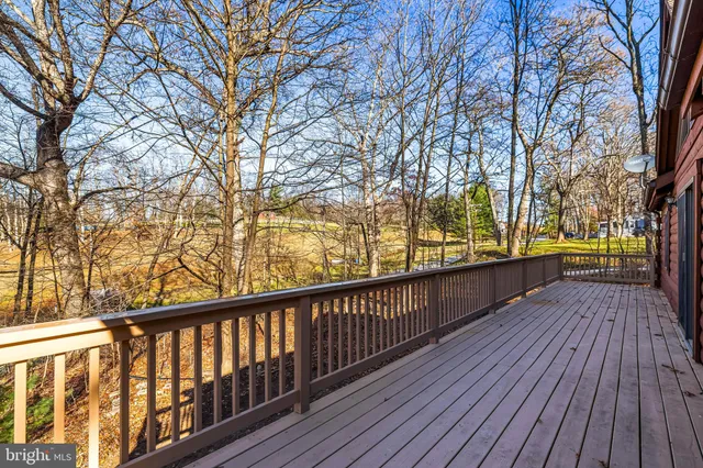 a view of balcony with wooden floor and trees