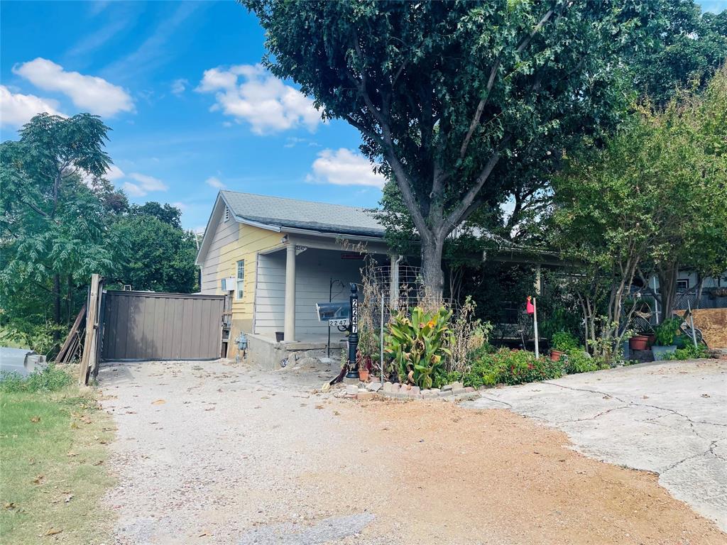 2247 Lovedale Avenue Dallas, TX 75235 - Photo 3 of 4 front view of a house with a yard and a garage
