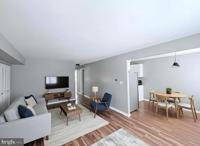 a living room with furniture a rug and a flat screen tv