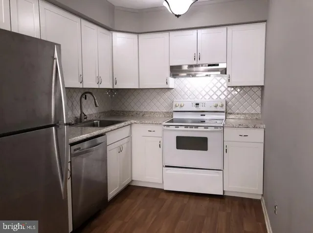 a kitchen with a white cabinets and white appliances