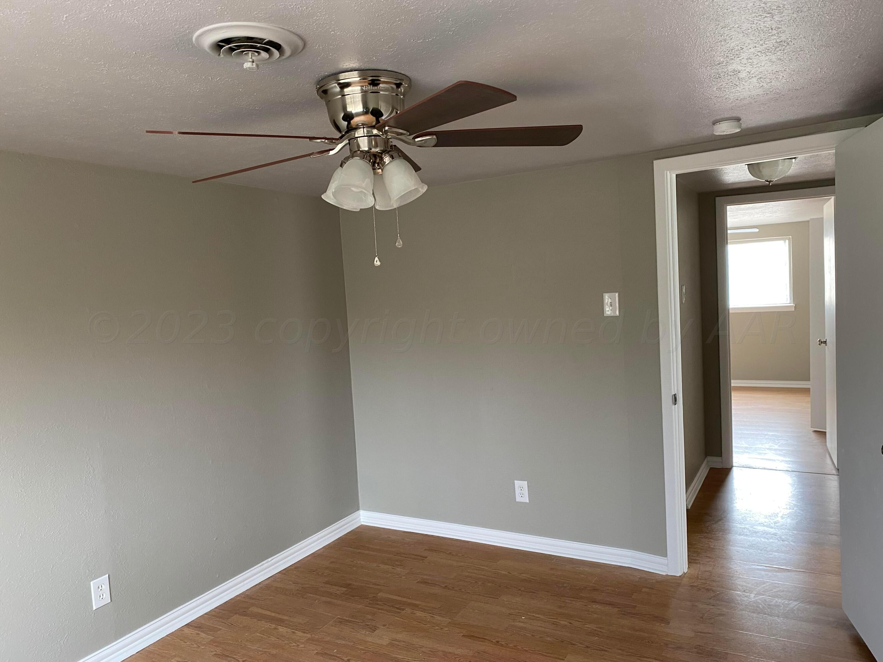 4700 Oregon Trail Amarillo, TX 79109 - Photo 7 of 9 a view of a room with wooden floor and fan