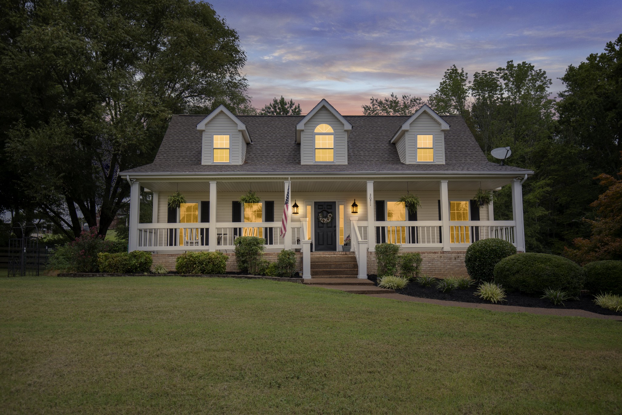 a front view of a house with garden