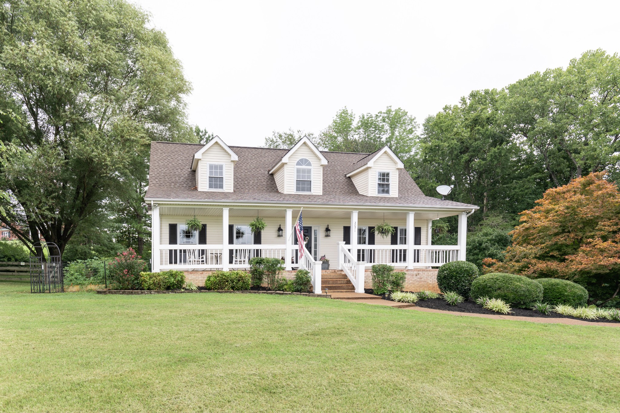 2071 Bradbury Road Adams, TN 37010 - Photo 4 of 47 a front view of a house with a garden and trees