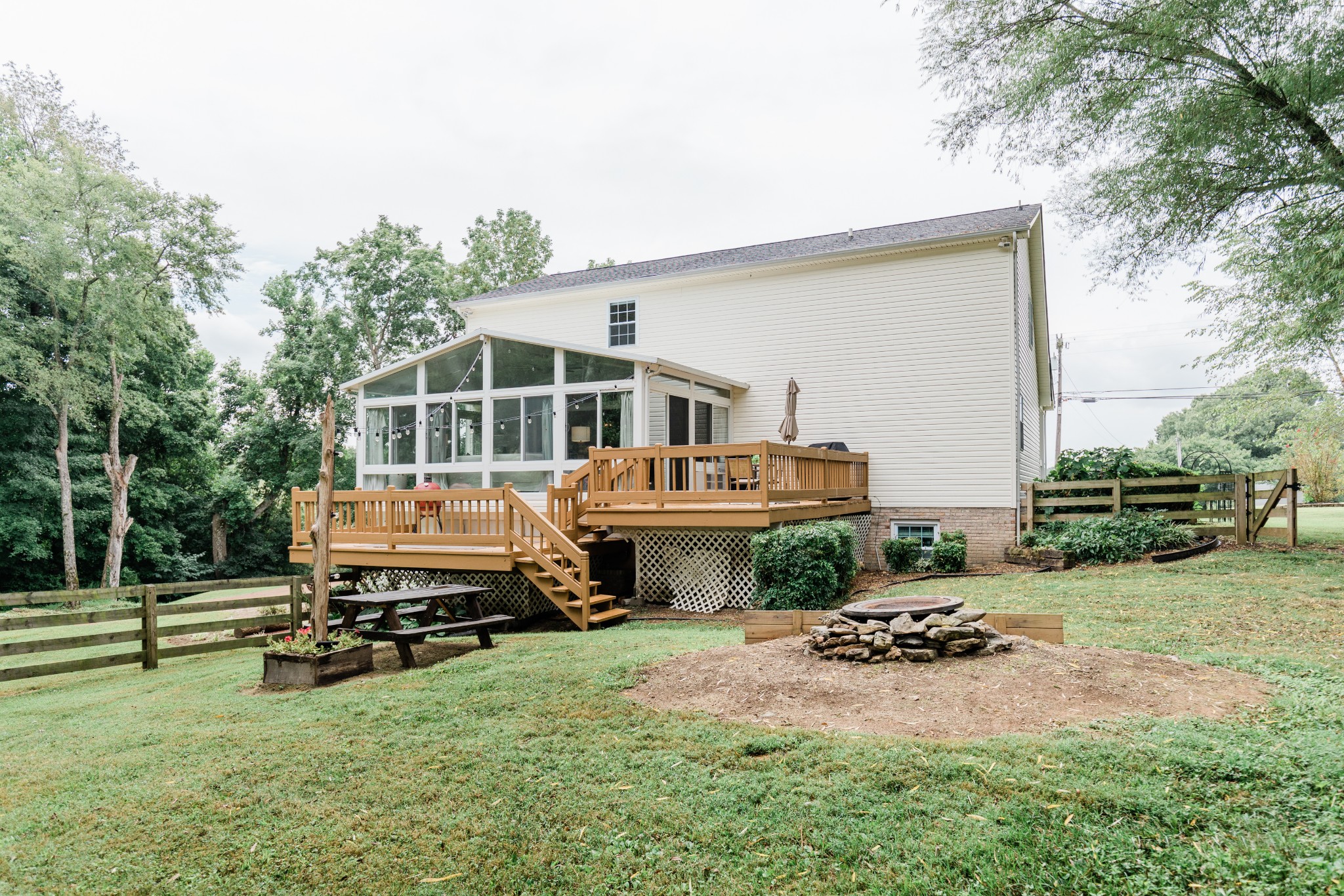 2071 Bradbury Road Adams, TN 37010 - Photo 45 of 47 a view of a house with backyard sitting area and garden