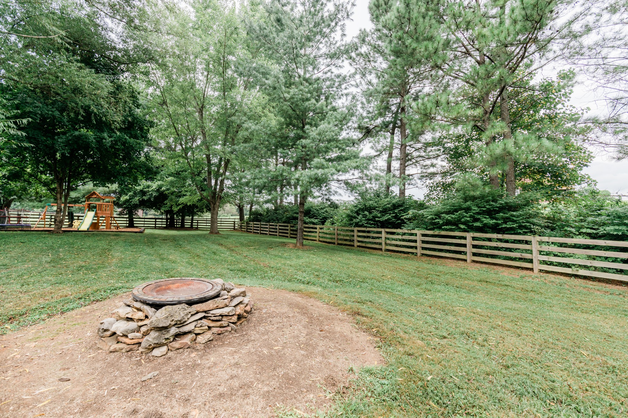 2071 Bradbury Road Adams, TN 37010 - Photo 46 of 47 a backyard of a house with lots of green space and fountain
