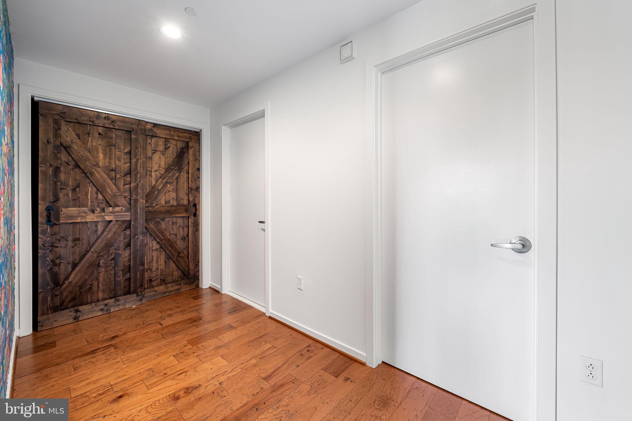 1200 Steuart Street, Unit 425 Baltimore, MD 21230 - Photo 11 of 33 a view of a room with wooden floor and closet