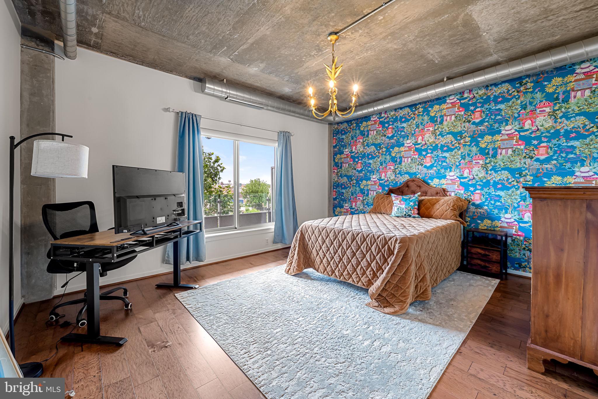 1200 Steuart Street, Unit 425 Baltimore, MD 21230 - Photo 12 of 33 a bedroom with a bed and a flat screen tv