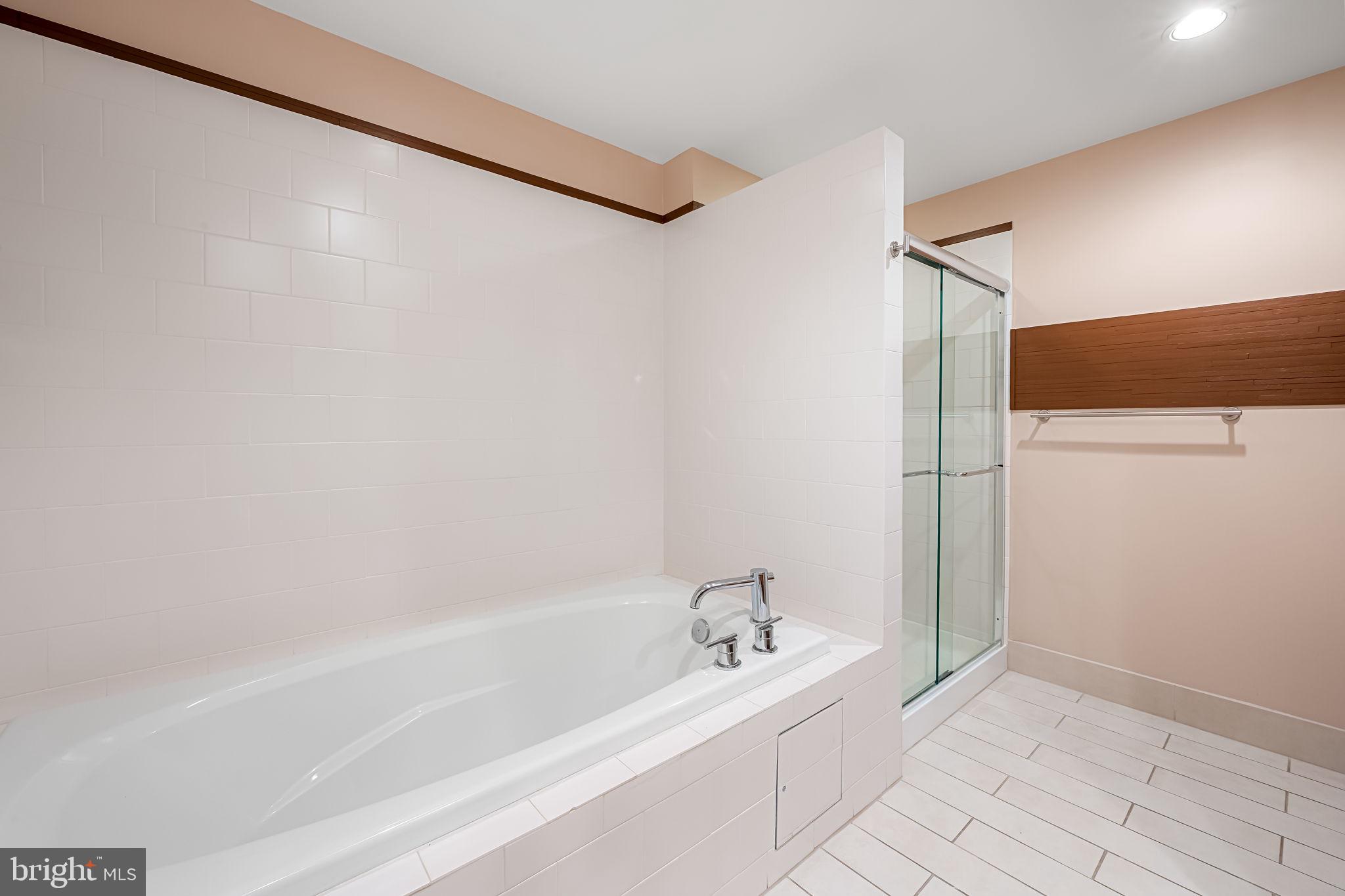 1200 Steuart Street, Unit 425 Baltimore, MD 21230 - Photo 15 of 33 a spacious bathroom with a bathtub and a shower
