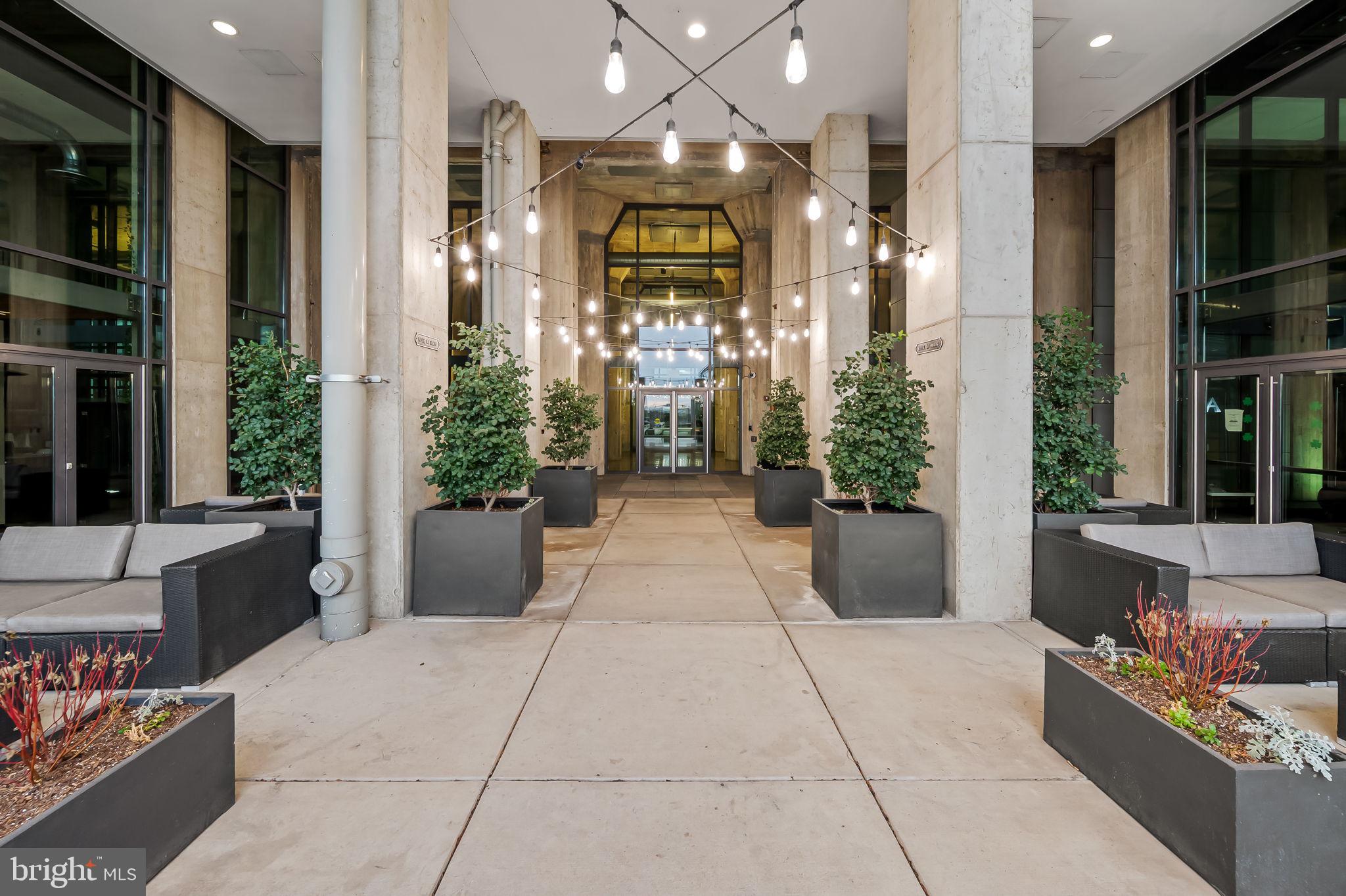 1200 Steuart Street, Unit 425 Baltimore, MD 21230 - Photo 3 of 33 a lobby with furniture and potted plants
