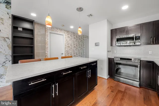 a kitchen with a sink appliances and cabinets