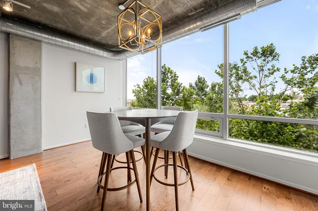 a view of a dining room with furniture window and wooden floor