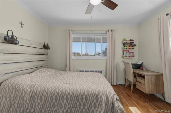 a bedroom with a bed and a desk