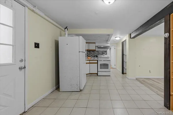 a view of a kitchen with a refrigerator and a stove top oven