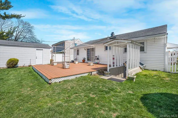 a view of a house with a backyard porch and sitting area