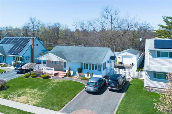 a view of an house with backyard space and sitting area