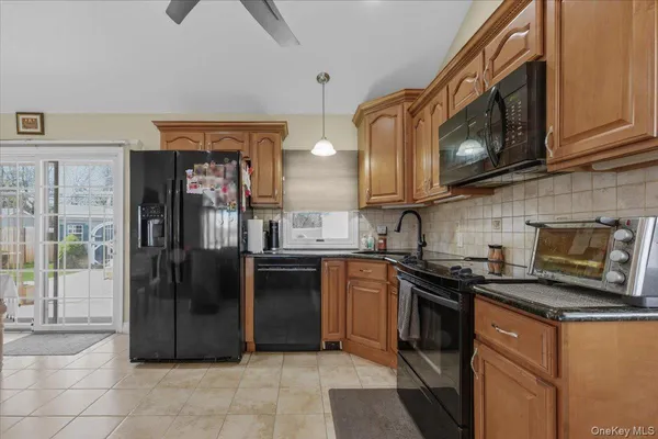 a kitchen with stainless steel appliances granite countertop a stove microwave and refrigerator