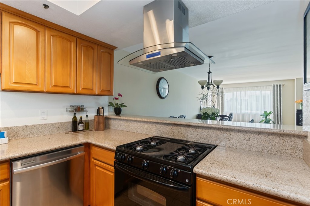 726 Elm Avenue, Unit 404 Long Beach, CA 90813 - Photo 6 of 31 a kitchen with granite countertop a sink a stove and cabinets