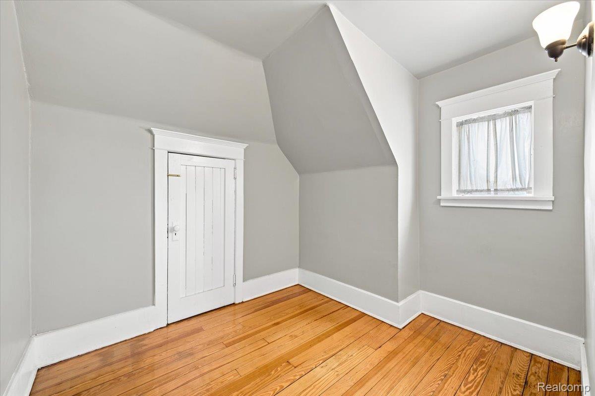 899 Edison Street Detroit, MI 48202 - Photo 26 of 37 Room featuring hardwood flooring and sloped ceilings