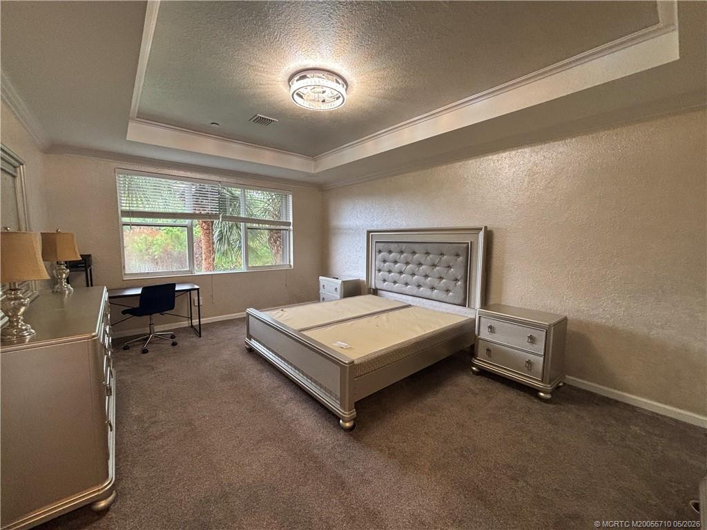 262 Southwest Walking Path, Unit 262 Stuart, FL 34997 - Photo 23 of 39 a bedroom with a bed and a window