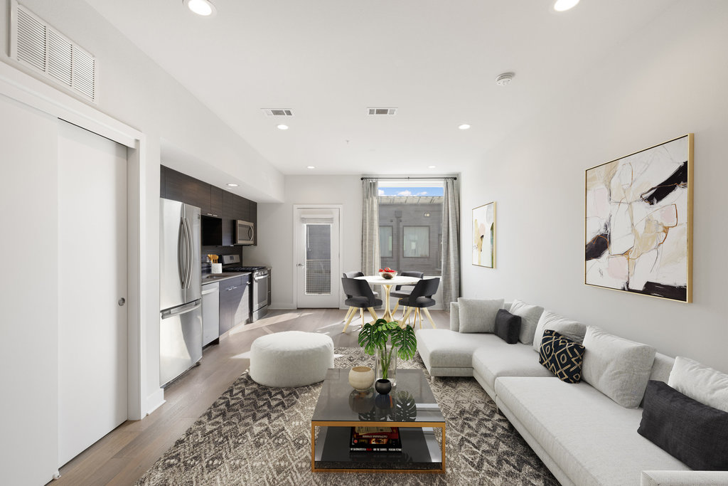 1800 East 4th Street, Unit 327 Austin, TX 78702 - Photo 2 of 20 a living room with furniture a flat screen tv and a table