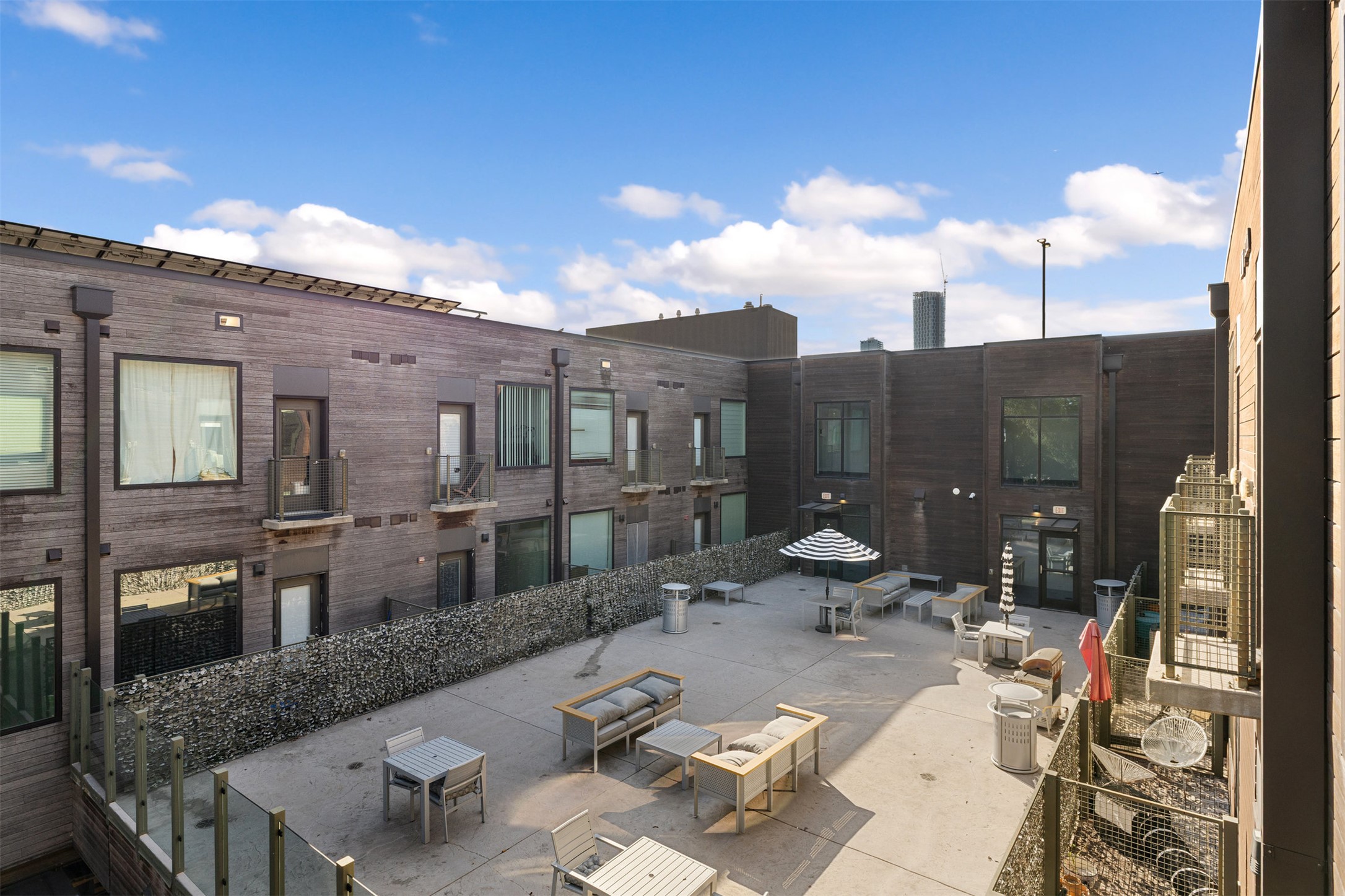 1800 East 4th Street, Unit 327 Austin, TX 78702 - Photo 6 of 20 a view of a patio with couches table and chairs and potted plants