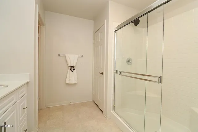 a en suite bathroom with a double vanity sink and a window