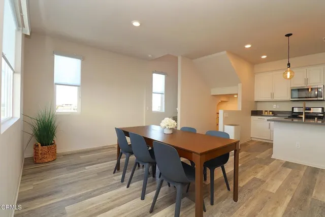 a living room with furniture and kitchen view