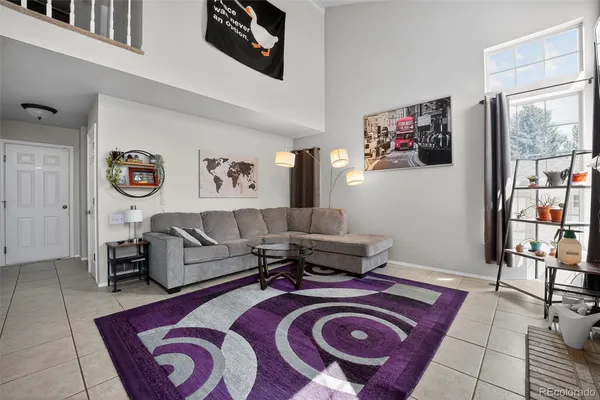 a living room with furniture and a rug