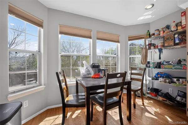 a dining room with furniture water view and a floor to ceiling window
