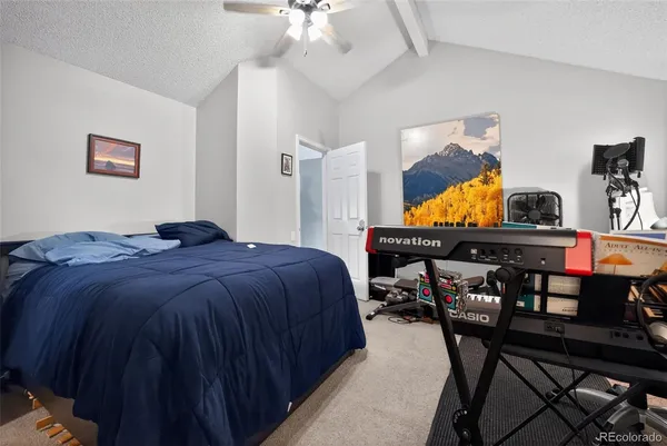 a bedroom with a bed and a dresser in it