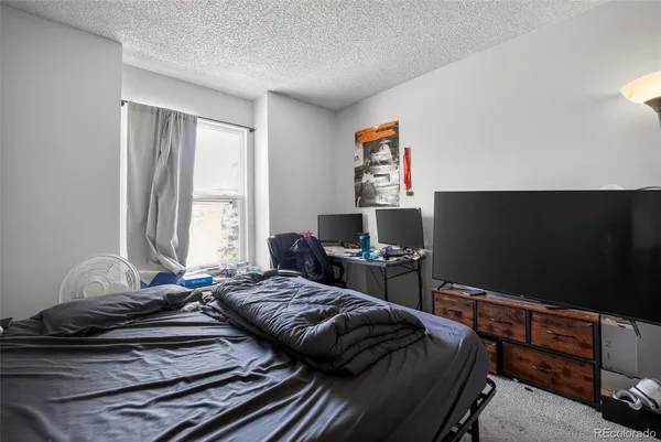 a bedroom with a bed and a desk