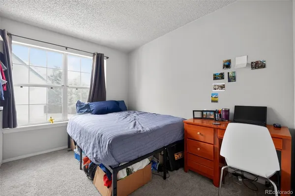 a bedroom with a bed and a table in it